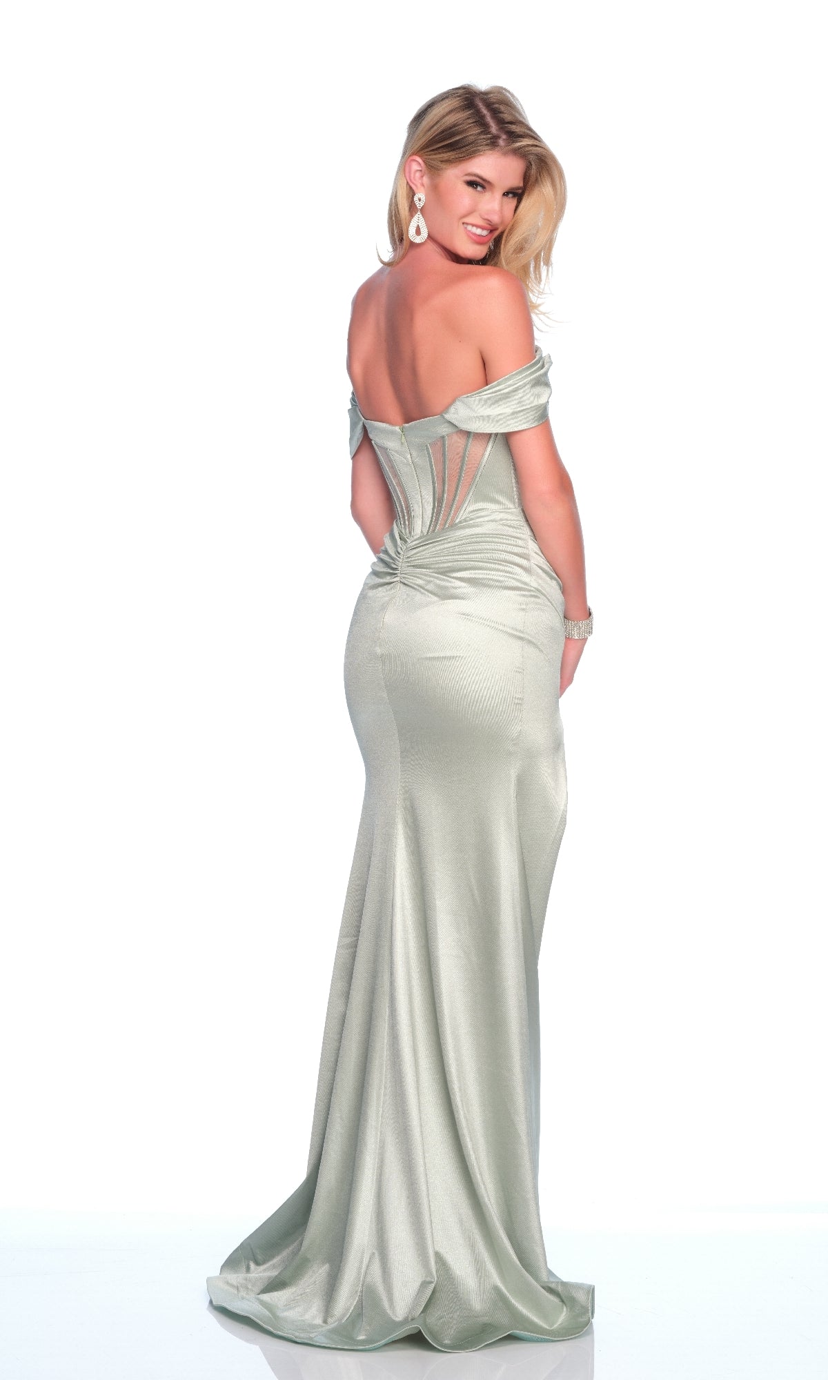 Woman wearing the Dave and Johnny 12186 long prom dress in light silver, featuring an off-the-shoulder neckline, fitted corset bodice, and long skirt, standing and smiling at the camera.